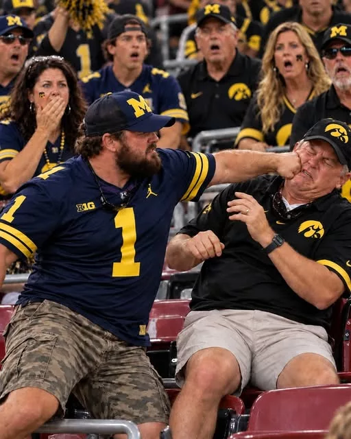 Cover Image for 🚨 SHOCKING VIDEO: Footage Appears to Show Michigan Wolverines Fan Hitting Iowa Hawkeyes Fan in Violent Postgame Brawl After 19–20 Loss [VIDEO]